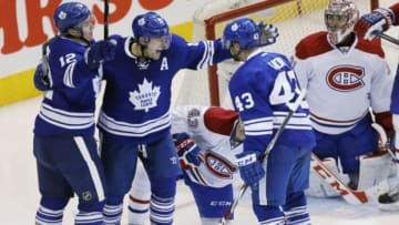 Mar 22, 2014; Toronto, Ontario, CAN; Toronto Maple Leafs forward Mason Raymond (12) and forward Joffrey Lupul (19) congratulate forward Nazem Kadri (43) on a goal against Montreal Canadiens goaltender Carey Price (31) during the third period at the Air Canada Centre. Montreal defeated Toronto 4-3. Mandatory Credit: John E. Sokolowski-USA TODAY Sports