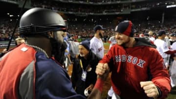 Oct 30, 2013; Boston, MA, USA; Boston Red Sox designated hitter David Ortiz (left) celebrates with starting pitcher Jon Lester (right) after game six of the MLB baseball World Series against the St. Louis Cardinals at Fenway Park. The Red Sox won 6-1 to win the series four games to two. Mandatory Credit: Robert Deutsch-USA TODAY Sports