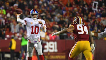 Jan 1, 2017; Landover, MD, USA; New York Giants quarterback Eli Manning (10) passes the ball as Washington Redskins linebacker Preston Smith (94) rushes during the second half at FedEx Field. Mandatory Credit: Brad Mills-USA TODAY Sports