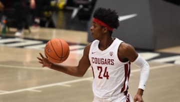 Feb 15, 2021; Pullman, Washington, USA; Washington State Cougars guard Noah Williams (24) brings the ball down court against the Washington Huskies in the first half at Friel Court at Beasley Coliseum. Mandatory Credit: James Snook-USA TODAY Sports