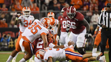 SANTA CLARA, CA - JANUARY 07: Jalen Hurts #2 of the Alabama Crimson Tide is tackled by Justin Foster #35 of the Clemson Tigers in the CFP National Championship presented by AT&T at Levi's Stadium on January 7, 2019 in Santa Clara, California. (Photo by Harry How/Getty Images)
