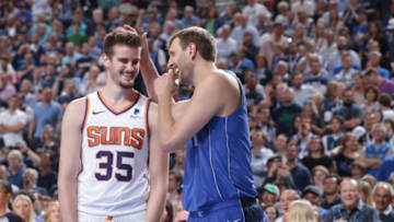 DALLAS, TX - APRIL 9: Dragan Bender #35 of the Phoenix Suns and Dirk Nowitzki #41 of the Dallas Mavericks interact during the game on April 9, 2019 at the American Airlines Center in Dallas, Texas. NOTE TO USER: User expressly acknowledges and agrees that, by downloading and or using this photograph, User is consenting to the terms and conditions of the Getty Images License Agreement. Mandatory Copyright Notice: Copyright 2019 NBAE (Photo by Glenn James/NBAE via Getty Images)