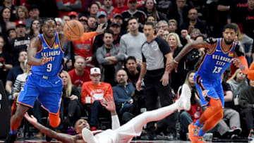 PORTLAND, OR - APRIL 14: Jerami Grant #9 of the Oklahoma City Thunder goes after a loose ball as Damian Lillard #0 of the Portland Trail Blazers sprawls on the court during the second half of the game at the Moda Center on April 14, 2019 in Portland, Oregon. The Blazers won 104-99. NOTE TO USER: User expressly acknowledges and agrees that, by downloading and or using this photograph, User is consenting to the terms and conditions of the Getty Images License Agreement. (Photo by Steve Dykes/Getty Images)
