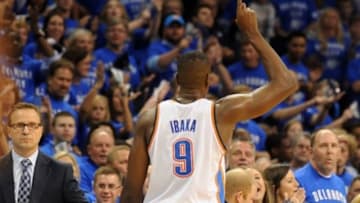 May 25, 2014; Oklahoma City, OK, USA; Oklahoma City Thunder head coach Scott Brooks slaps hands with forward Serge Ibaka (9) as he leaves the court against the San Antonio Spurs during the fourth quarter in game three of the Western Conference Finals of the 2014 NBA Playoffs at Chesapeake Energy Arena. Mandatory Credit: Mark D. Smith-USA TODAY Sports
