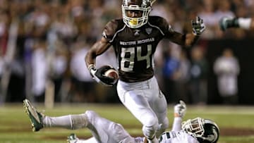 Sep 4, 2015; Kalamazoo, MI, USA; Western Michigan Broncos wide receiver Corey Davis (84) runs though the tackle of Michigan State Spartans linebacker Darien Harris (45) during the 2nd half of a game at Waldo Stadium. Mandatory Credit: Mike Carter-USA TODAY Sports