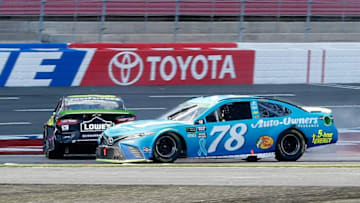 CHARLOTTE, NC - SEPTEMBER 30: Martin Truex Jr., driver of the #78 Auto-Owners Insurance Toyota, and Jimmie Johnson, driver of the #48 Lowe's for Pros Chevrolet, are involved in an on-track incident on the last lap of the Monster Energy NASCAR Cup Series Bank of America Roval 400 at Charlotte Motor Speedway on September 30, 2018 in Charlotte, North Carolina. (Photo by Brian Lawdermilk/Getty Images)