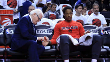 TORONTO, ON - MAY 15: DeMar DeRozan #10 of the Toronto Raptors has his injured thumb wrapped in a red shoelace by the Raptors sports science director Alex McKechnie prior to Game Seven of the Eastern Conference Quarterfinals against the Miami Heat during the 2016 NBA Playoffs at the Air Canada Centre on May 15, 2016 in Toronto, Ontario, Canada. NOTE TO USER: User expressly acknowledges and agrees that, by downloading and or using this photograph, User is consenting to the terms and conditions of the Getty Images License Agreement. (Photo by Vaughn Ridley/Getty Images)