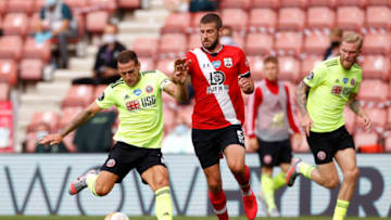 SOUTHAMPTON, ENGLAND - JULY 26: Billy Sharp of Sheffield United under pressure from Jack Stephens of Southampton during the Premier League match between Southampton FC and Sheffield United at St Mary's Stadium on July 26, 2020 in Southampton, England. Football Stadiums around Europe remain empty due to the Coronavirus Pandemic as Government social distancing laws prohibit fans inside venues resulting in all fixtures being played behind closed doors. (Photo by Andrew Boyers/Pool via Getty Images)