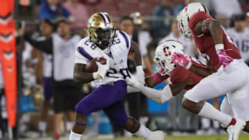 PALO ALTO, CALIFORNIA - OCTOBER 05: Richard Newton #28 of the Washington Huskies fights off the tackle of Malik Antoine #3 of the Stanford Cardinal during the third quarter of an NCAA football game at Stanford Stadium on October 05, 2019 in Palo Alto, California. (Photo by Thearon W. Henderson/Getty Images)