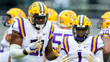 Auburn footballApr 17, 2021; Baton Rouge, Louisiana, USA; LSU Tigers offensive tackle Dare Rosenthal (51) and LSU Tigers wide receiver Kayshon Boutte (1) pose for the camera on a time out during the first half of the annual Purple and White spring game at Tiger Stadium. Mandatory Credit: Stephen Lew-USA TODAY Sports