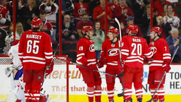 Apr 7, 2016; Raleigh, NC, USA; Carolina Hurricanes forward Riley Nash (20) celebrates with teammates after scoring a goal in the first period against the Montreal Canadiens at PNC Arena. Mandatory Credit: James Guillory-USA TODAY Sports