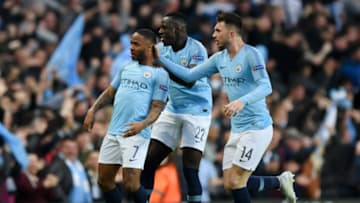 Raheem Sterling of Manchester City celebrates with teammates Benjamin Mendy and Aymeric Laporte. (Photo by Shaun Botterill/Getty Images)