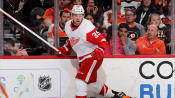 PHILADELPHIA, PENNSYLVANIA - FEBRUARY 16: Anthony Mantha #39 of the Detroit Red Wings hits Claude Giroux #28 of the Philadelphia Flyers at Wells Fargo Center on February 16, 2019 in Philadelphia, Pennsylvania.The Philadelphia Flyers defeated the Detroit Red Wings 6-5 in overtime. (Photo by Elsa/Getty Images)