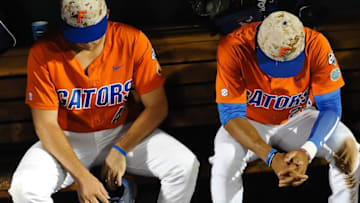 Jun 20, 2015; Omaha, NE, USA; Florida Gators outfielder Buddy Reed (23) and infielder John Sternagel (44) sit iin the dugout after the loss against the Virginia Cavaliers in the 2015 College World Series at TD Ameritrade Park. Mandatory Credit: Steven Branscombe-USA TODAY Sports