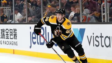BOSTON, MA - SEPTEMBER 23: Boston Bruins defenseman Urho Vaakanainen (58) looks to clear the puck during a preseason game between the Boston Bruins and the Philadelphia Flyers on September 23, 2019, at TD Garden in Boston, Massachusetts. (Photo by Fred Kfoury III/Icon Sportswire via Getty Images)