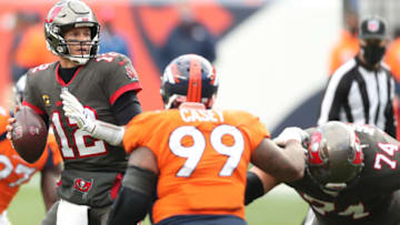 DENVER, COLORADO - SEPTEMBER 27: Quarterback Tom Brady #12 of the Tampa Bay Buccaneers looks to pass as he is pressured by defensive end Jurrell Casey #99 of the Denver Broncos during the second half at Empower Field At Mile High on September 27, 2020 in Denver, Colorado. (Photo by Matthew Stockman/Getty Images)