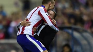 Atletico Madrid's French forward Antoine Griezmann (L) celebrates with Atletico Madrid's Argentinian coach Diego Simeone after scoring their third goal during the UEFA Champions League football match Club Atletico de Madrid vs Malmo FF at the Vicente Calderon stadium in Madrid on October 22, 2014. AFP PHOTO/ JAVIER SORIANO (Photo credit should read JAVIER SORIANO/AFP/Getty Images)