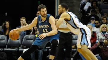 Dec 15, 2013; Memphis, TN, USA; Minnesota Timberwolves power forward Kevin Love (42) dribbles the ball as Memphis Grizzlies small forward Tayshaun Prince (21) defends during the second quarter at FedExForum. Mandatory Credit: Justin Ford-USA TODAY Sports