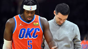 Luguentz Dort #5 and head coach Mark Daigneault of the Oklahoma City Thunder walk back to the bench after Dort and Kevin Love #0 of the Cleveland Cavaliers started a fight during the fourth quarter at Rocket Mortgage Fieldhouse on January 22, 2022 in Cleveland, Ohio. Dort was later ejected from the game after being charged with a flagrant two foul for the altercation. The Cavaliers defeated the Thunder 94-87. NOTE TO USER: User expressly acknowledges and agrees that, by downloading and/or using this photograph, user is consenting to the terms and conditions of the Getty Images License Agreement. (Photo by Jason Miller/Getty Images)