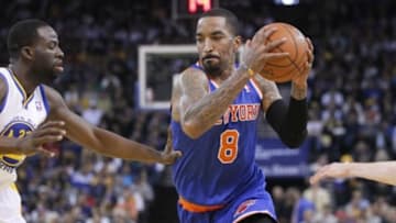 Mar 30, 2014; Oakland, CA, USA; New York Knicks guard J.R. Smith (8) dribbles the ball around Golden State Warriors forward Draymond Green (23) in the second quarter at Oracle Arena. Mandatory Credit: Cary Edmondson-USA TODAY Sports