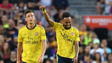 BARCELONA, SPAIN - AUGUST 04: Pierre-Emerick Aubameyang of Arsenal celebrates with his tem mate Mesut Ozil after scoring his team's first goalduring the Joan Gamper trophy friendly match between FC Barcelona and Arsenal at Nou Camp on August 04, 2019 in Barcelona, Spain. (Photo by David Ramos/Getty Images)