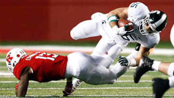 PISCATAWAY, NJ - NOVEMBER 25: Joe Bachie #35 of the Michigan State Spartans jumps over Gus Edwards #13 of the Rutgers Scarlet Knights during their game on November 25, 2017 in Piscataway, New Jersey. (Photo by Jeff Zelevansky/Getty Images)