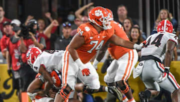 Clemson quarterback D.J. Uiagalelei(5) is sacked by Georgia linebacker Nolan Smith(4) near offensive lineman Marcus Tate(74) during the first quarter of the Duke's Mayo Classic Sep 4, 2021; Charlotte, North Carolina, USA; at Bank of America Stadium.Ncaa Football Georgia At Clemson