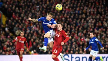 LIVERPOOL, ENGLAND - DECEMBER 04: Lucas Digne of Everton heads clear of Xherdan Shaqiri of Liverpool during the Premier League match between Liverpool FC and Everton FC at Anfield on December 04, 2019 in Liverpool, United Kingdom. (Photo by Laurence Griffiths/Getty Images)