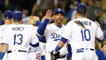 LOS ANGELES, CALIFORNIA - OCTOBER 03: Manager Dave Roberts of the Los Angeles Dodgers celebrates with Justin Turner #10 after the Dodgers defeated the Washington Nationals 6-0 in game one of the National League Division Series at Dodger Stadium on October 03, 2019 in Los Angeles, California. (Photo by Sean M. Haffey/Getty Images)