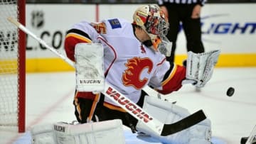 March 11, 2013; Los Angeles, CA, USA; Calgary Flames goalie Joey MacDonald (35) blocks a shot against the Los Angeles Kings during the third period at Staples Center. Mandatory Credit: Gary A. Vasquez-USA TODAY Sports