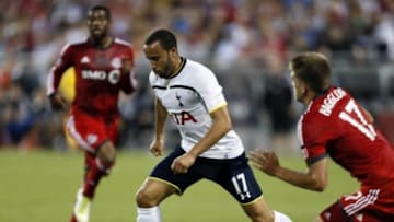 Jul 23, 2014; Toronto, Ontario, Canada; Tottenham Hotspur midfielder Andros Townsend (17) carries the ball in front of Toronto FC defender Nick Hagglund (17) before taking the shot to score the winning goal at BMO Field. Tottenham defeated Toronto 3-2. Mandatory Credit: John E. Sokolowski-USA TODAY Sports