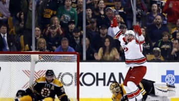 Mar 10, 2016; Boston, MA, USA; Carolina Hurricanes left wing Phillip Di Giuseppe (34) celebrates after scoring the winning goal on Boston Bruins goalie Tuukka Rask (40) with center Patrice Bergeron (37) in the net during the overtime period at TD Garden. The Carolina Hurricanes won 3-2 in overtime. Mandatory Credit: Greg M. Cooper-USA TODAY Sports