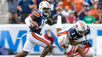 Auburn football defensive back Nehemiah Pritchett (18) returns an interception against Houston during the Birmingham Bowl at Protective Stadium in Birmingham, Ala., on Tuesday December 28, 2021.Bham35