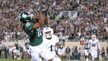 Sep 2, 2016; East Lansing, MI, USA; Michigan State Spartans wide receiver Felton Davis III (18) makes a catch in front of Furman Paladins cornerback Nick Miller (1) to score a touchdown during the first half at Spartan Stadium. Mandatory Credit: Mike Carter-USA TODAY Sports