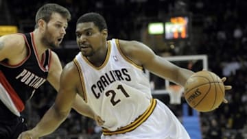 Dec 17, 2013; Cleveland, OH, USA; Cleveland Cavaliers center Andrew Bynum (21) drives against Portland Trail Blazers center Joel Freeland (19) in the fourth quarter at Quicken Loans Arena. Mandatory Credit: David Richard-USA TODAY Sports