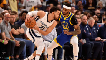 MEMPHIS, TENNESSEE - MAY 01: Tyus Jones #21 of the Memphis Grizzlies handles the ball against Gary Payton II #0 of the Golden State Warriors during Game One of the Western Conference Semifinals of the NBA Playoffs at FedExForum on May 01, 2022 in Memphis, Tennessee. NOTE TO USER: User expressly acknowledges and agrees that, by downloading and or using this photograph, User is consenting to the terms and conditions of the Getty Images License Agreement. (Photo by Justin Ford/Getty Images)