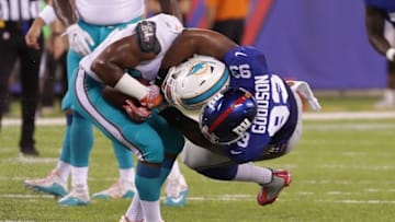 Aug 12, 2016; East Rutherford, NJ, USA; New York Giants outside linebacker B.J. Goodson (93) tackles Miami Dolphins running back Jay Ajayi (23) during the first half of the preseason game at MetLife Stadium. Mandatory Credit: Vincent Carchietta-USA TODAY Sports
