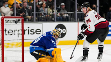 Feb 5, 2022; Las Vegas, Nevada, USA; Central Division goalie Juuse Saros (74) of the Nashville Predators deflects the puck against Atlantic Division defender Rasmus Dahlin (26) of the Buffalo Sabres during the 2022 NHL All-Star Game at T-Mobile Arena. Mandatory Credit: Stephen R. Sylvanie-USA TODAY Sports