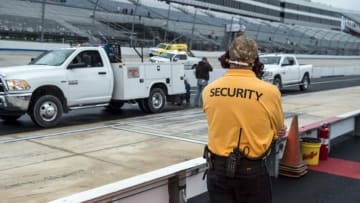 Sep 30, 2016; Dover, DE, USA; A member of track security watches as the jet air dryers clear the track before the qualifying session for the Citizen Soldier 400 at Dover International Speedway. Mandatory Credit: Jerome Miron-USA TODAY Sports