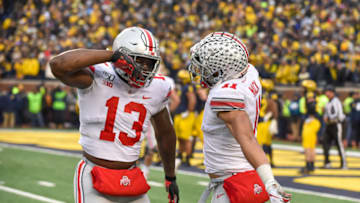 ANN ARBOR, MICHIGAN - NOVEMBER 30: Rashod Berry #13 and Austin Mack #11 of the Ohio State Buckeyes celebrate a touchdown during the second half of a college football game against the Michigan Wolverines at Michigan Stadium on November 30, 2019 in Ann Arbor, Michigan. The Ohio State Buckeyes won the game 56-27 over the Michigan Wolverines. (Photo by Aaron J. Thornton/Getty Images)