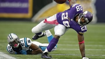 Oct 13, 2013; Minneapolis, MN, USA; Minnesota Vikings running back Adrian Peterson (28) breaks the tackle of Carolina Panthers cornerback Melvin White (23) in the second quarter at Mall of America Field at H.H.H. Metrodome. Panthers win 35-10. Mandatory Credit: Bruce Kluckhohn-USA TODAY Sports
