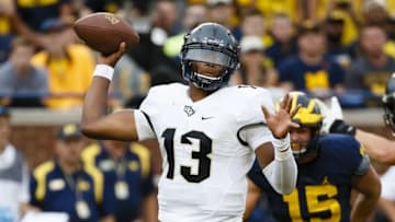 Sep 10, 2016; Ann Arbor, MI, USA; UCF Knights quarterback Justin Holman (13) passes in the second quarter against the Michigan Wolverines at Michigan Stadium. Mandatory Credit: Rick Osentoski-USA TODAY Sports