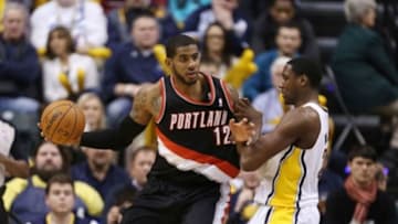 Feb 7, 2014; Indianapolis, IN, USA; Portland Trail Blazers forward LaMarcus Aldridge (12) is guarded by Indiana Pacers center Ian Mahinmi (28) at Bankers Life Fieldhouse. Indiana defeats Portland 118-113 in overtime. Mandatory Credit: Brian Spurlock-USA TODAY Sports