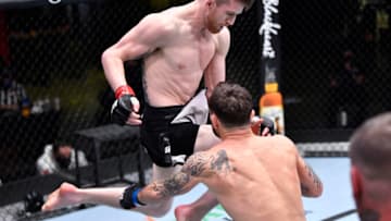 LAS VEGAS, NEVADA - FEBRUARY 06: In this handout image provided by UFC, Cory Sandhagen lands a flying knee to knock out Frankie Edgar in their bantamweight fight during the UFC Fight Night event at UFC APEX on February 06, 2021 in Las Vegas, Nevada. (Photo by Chris Unger/Zuffa LLC via Getty Images)