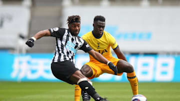 NEWCASTLE UPON TYNE, ENGLAND - APRIL 04: Allan Saint-Maximin of Newcastle United and Davinson Sanchez of Tottenham Hotspur during the Premier League match between Newcastle United and Tottenham Hotspur at St. James Park on April 4, 2021 in Newcastle upon Tyne, United Kingdom. Sporting stadiums around the UK remain under strict restrictions due to the Coronavirus Pandemic as Government social distancing laws prohibit fans inside venues resulting in games being played behind closed doors. (Photo by Robbie Jay Barratt - AMA/Getty Images)