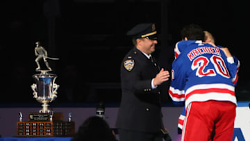 NEW YORK, NEW YORK - APRIL 26: Chris Kreider #20 of the New York Rangers is presented the Steven McDonald Extra Effort Award prior to the game against the Carolina Hurricanes at Madison Square Garden on April 26, 2022 in New York City. (Photo by Bruce Bennett/Getty Images)