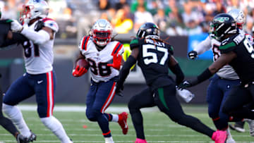 EAST RUTHERFORD, NEW JERSEY - OCTOBER 30: Rhamondre Stevenson #38 of the New England Patriots runs with the ball as C.J. Mosley #57 of the New York Jets defends during the second half at MetLife Stadium on October 30, 2022 in East Rutherford, New Jersey. (Photo by Mike Stobe/Getty Images)