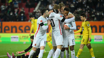 Augsburg players celebrate their equaliser against Borussia Dortmund. (Photo by Sebastian Widmann/Getty Images)