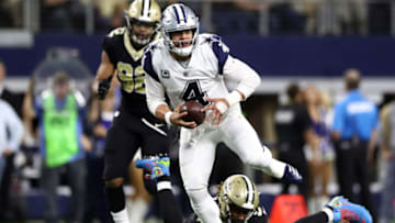ARLINGTON, TEXAS - NOVEMBER 29: Dak Prescott #4 of the Dallas Cowboys runs the ball Cameron Jordan #94 of the New Orleans Saints in the second quarter at AT&T Stadium on November 29, 2018 in Arlington, Texas. (Photo by Ronald Martinez/Getty Images)