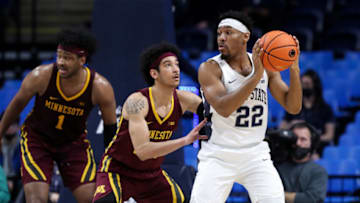 Feb 17, 2022; University Park, Pennsylvania, USA; Penn State Nittany Lions guard Jalen Pickett (22) holds the ball against Minnesota Golden Gophers guard Eylijah Stephens (20) during the second half at Bryce Jordan Center. Penn State won 67-46. Mandatory Credit: Matthew OHaren-USA TODAY Sports